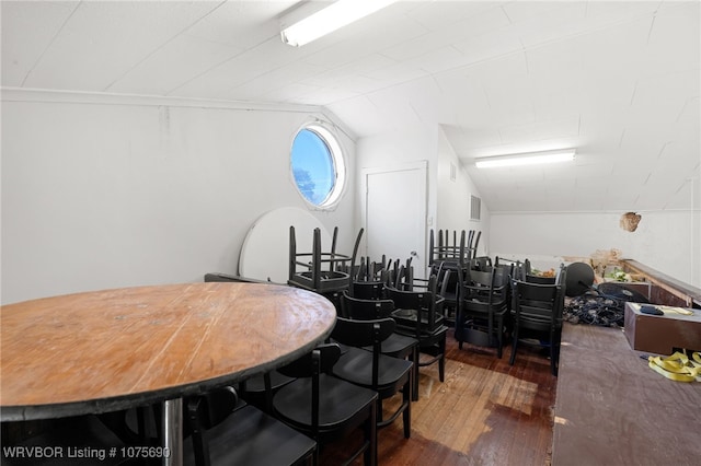 dining area with dark hardwood / wood-style floors and lofted ceiling