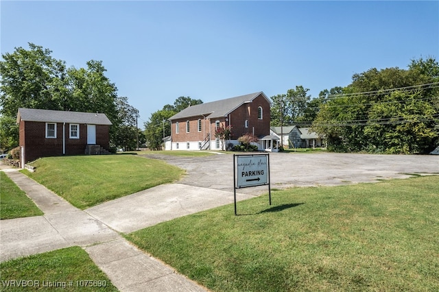 view of front of property with a garage and a front lawn