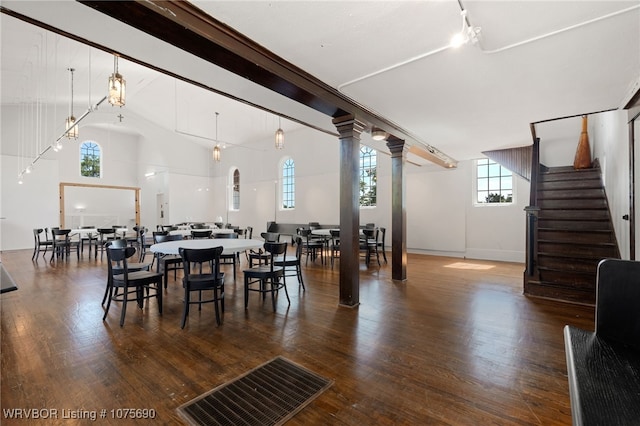 dining space with lofted ceiling and dark wood-type flooring