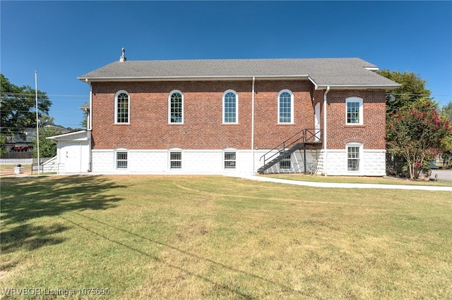 back of property featuring a lawn