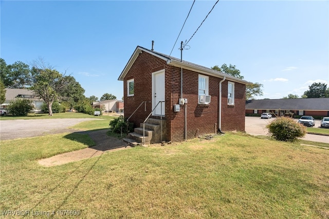 bungalow-style house with cooling unit and a front yard