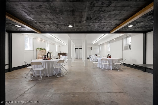 unfurnished dining area featuring concrete flooring