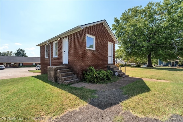 view of property exterior with a yard