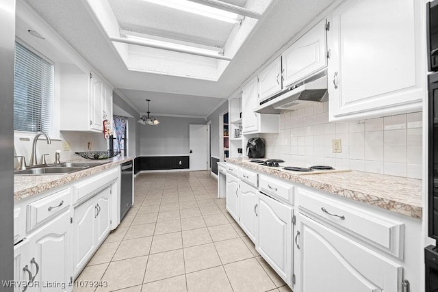 kitchen featuring light tile patterned flooring, a sink, white cabinetry, and under cabinet range hood