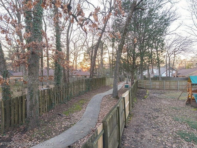 view of yard with a playground and a fenced backyard