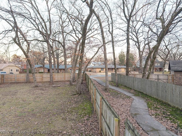 view of yard with a fenced backyard and a residential view