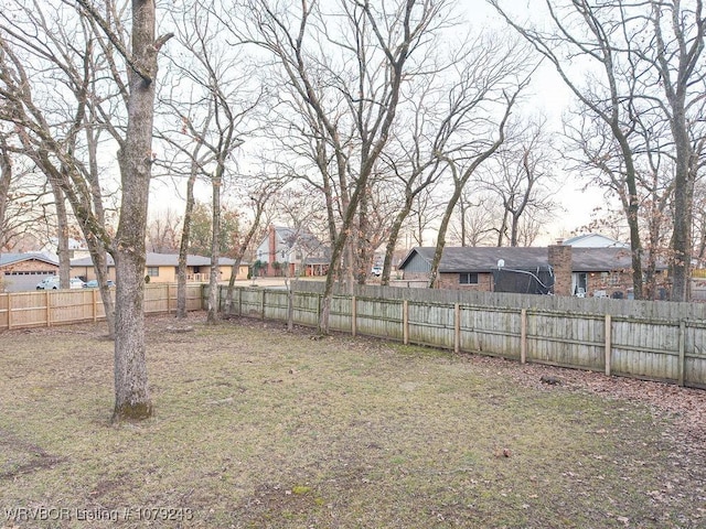 view of yard featuring a residential view and a fenced backyard