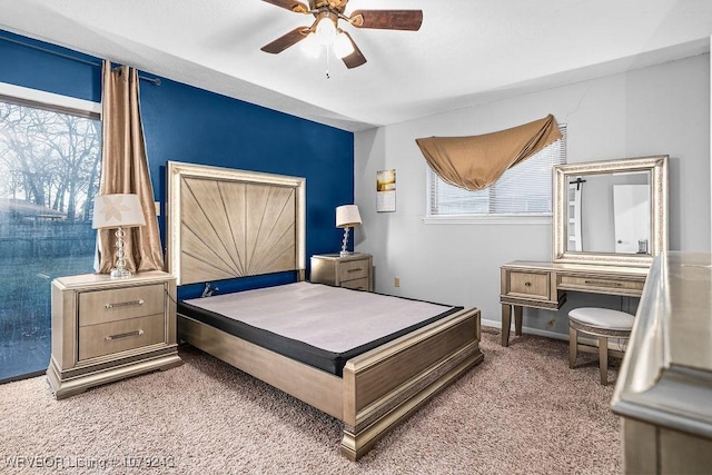 carpeted bedroom featuring ceiling fan and baseboards