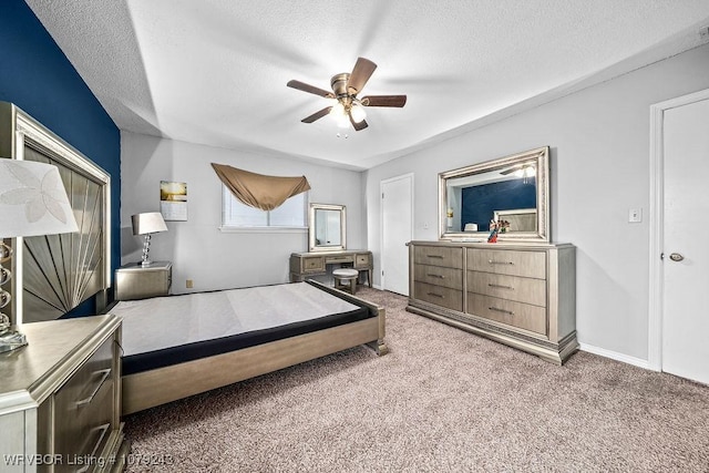 carpeted bedroom featuring a ceiling fan and a textured ceiling