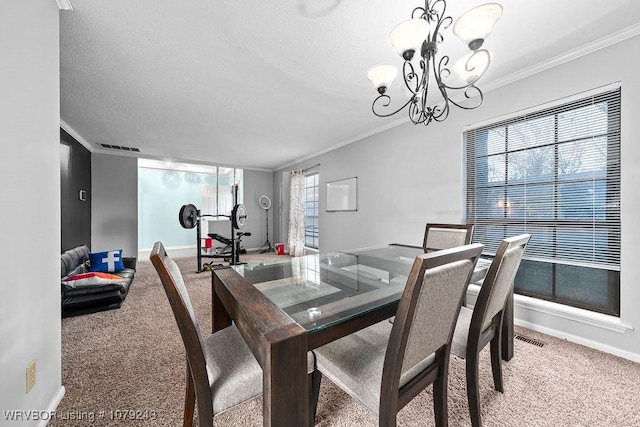 carpeted dining area featuring a notable chandelier, visible vents, baseboards, and crown molding