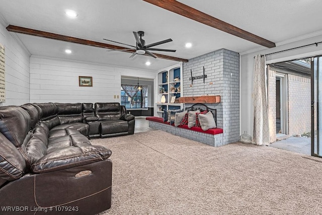 living area featuring a ceiling fan, carpet, a brick fireplace, beam ceiling, and recessed lighting