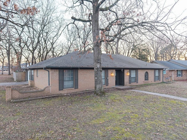 single story home with brick siding and roof with shingles