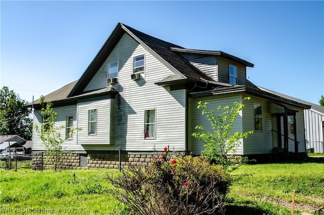 rear view of property with a yard