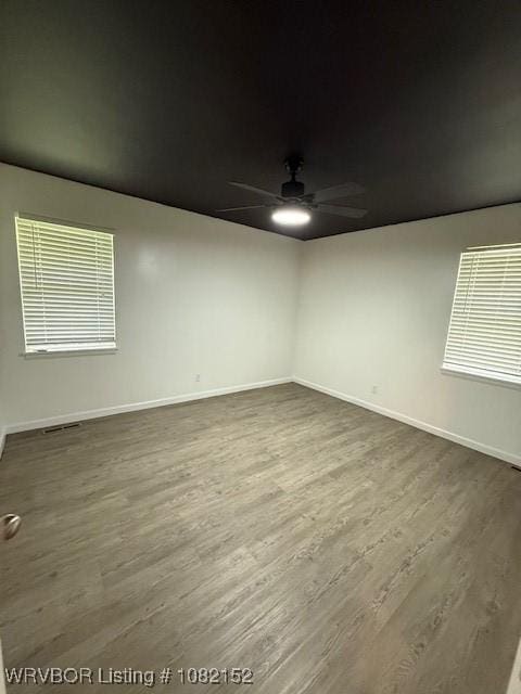 503 E Mayo Dr, Sallisaw, OK 74955 - spare room with ceiling fan and dark wood-type flooring
