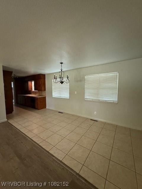 503 E Mayo Dr, Sallisaw, OK 74955 - unfurnished dining area featuring a chandelier and light tile patterned floors