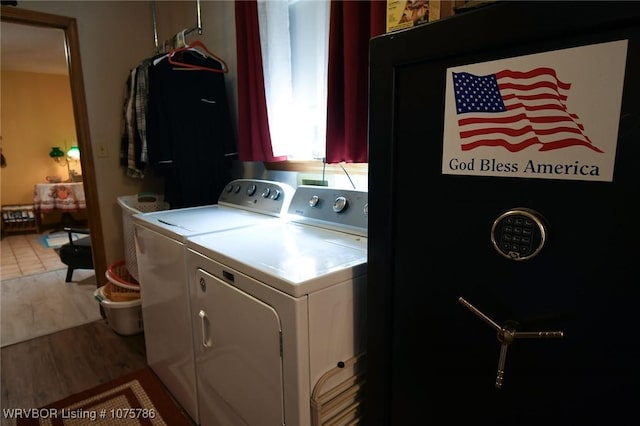 laundry area featuring independent washer and dryer and light hardwood / wood-style flooring