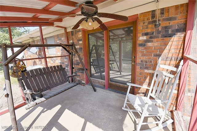 unfurnished sunroom with ceiling fan and vaulted ceiling