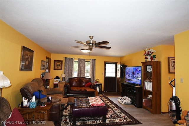 living room with light wood-type flooring and ceiling fan