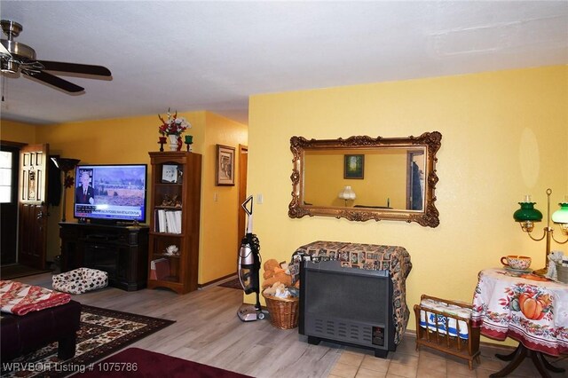 living room featuring ceiling fan and light hardwood / wood-style floors