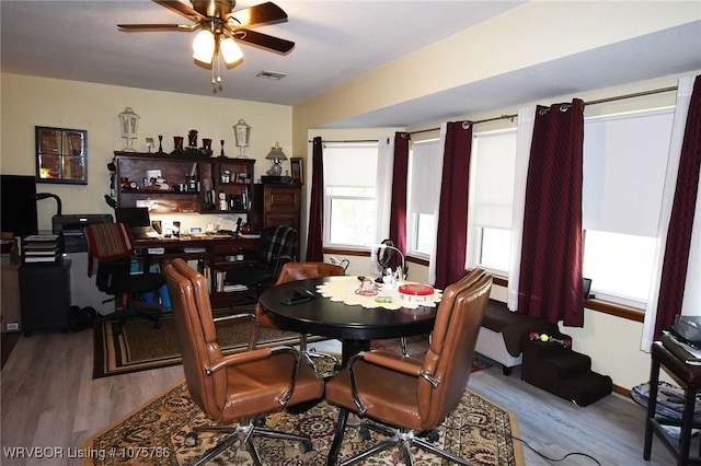 dining room with ceiling fan and light hardwood / wood-style floors