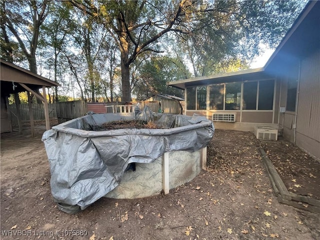 view of swimming pool featuring a sunroom