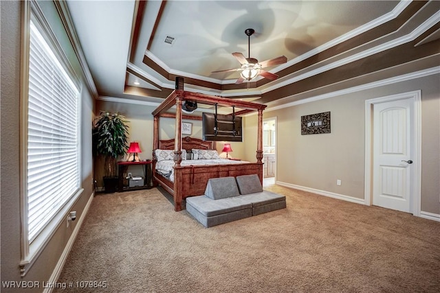 bedroom featuring a tray ceiling, crown molding, baseboards, carpet floors, and visible vents