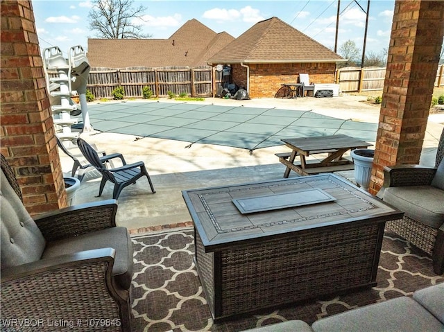 view of pool with a fenced in pool, a fenced backyard, and a patio area