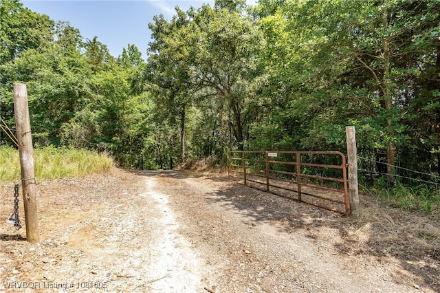 799 Sugar Maple Bnd, Rudy, AR 72952 - view of dirt / gravel road featuring a gate and a forest view