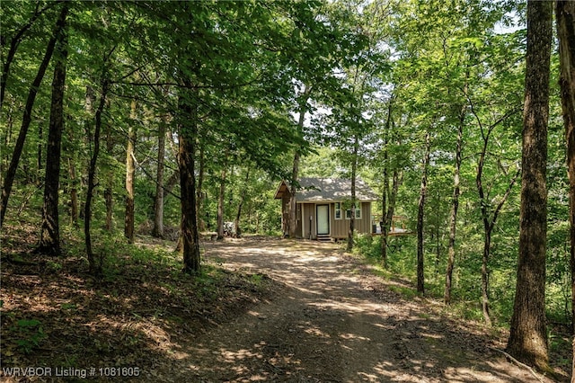 799 Sugar Maple Bnd, Rudy, AR 72952 - view of front facade with driveway, an outdoor structure, and a wooded view