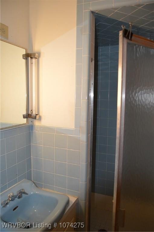 bathroom featuring a shower with shower door