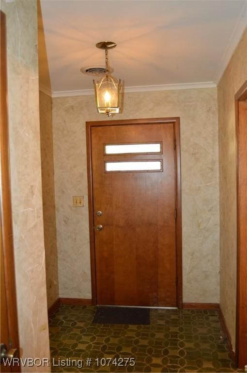 foyer featuring ornamental molding