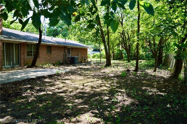 view of yard with a patio area and central AC