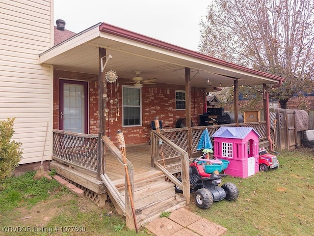 deck with ceiling fan and a lawn