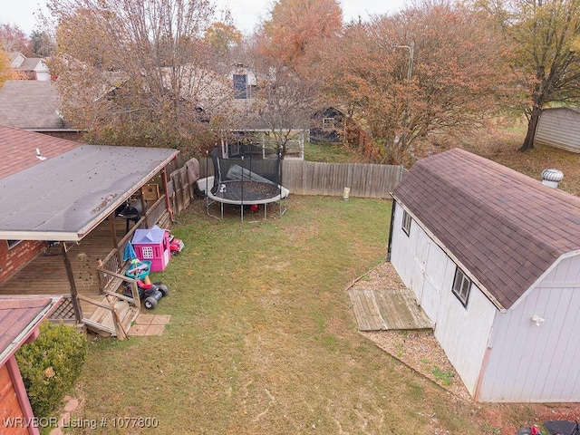 view of yard with a trampoline and a shed