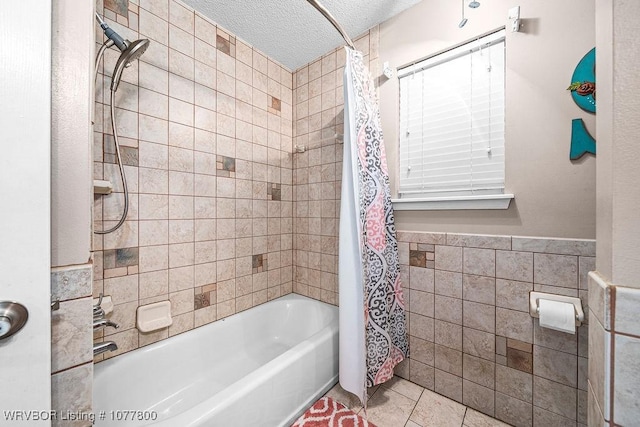 bathroom with tile walls, tile patterned flooring, shower / bath combination with curtain, and a textured ceiling