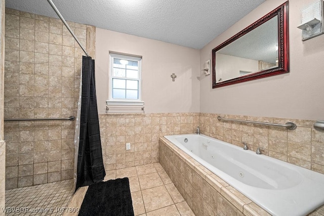 bathroom featuring plus walk in shower, tile patterned flooring, a textured ceiling, and tile walls