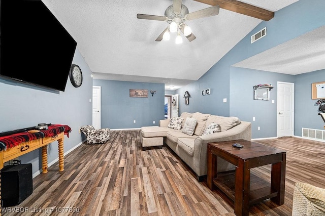 living room with ceiling fan, wood-type flooring, lofted ceiling with beams, and a textured ceiling