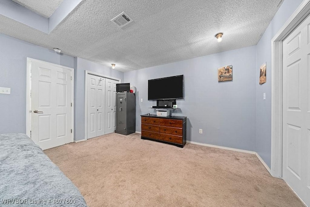 carpeted bedroom featuring a textured ceiling