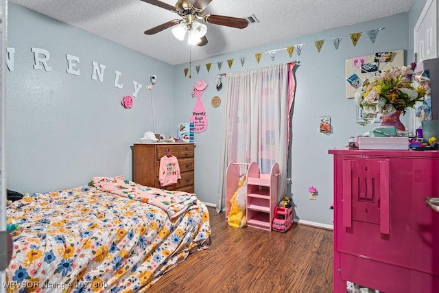 bedroom featuring ceiling fan, a textured ceiling, and dark hardwood / wood-style flooring