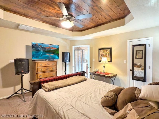 bedroom with carpet, wood ceiling, visible vents, and a raised ceiling