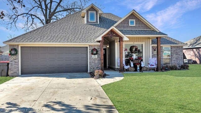 view of front of property with a garage and a front lawn