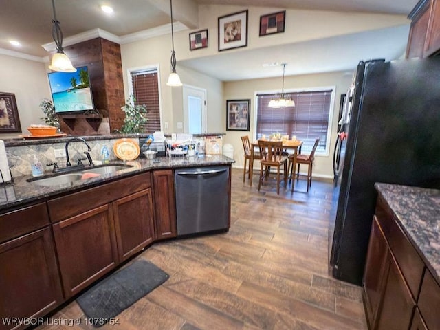 kitchen featuring a sink, hanging light fixtures, dishwasher, and freestanding refrigerator