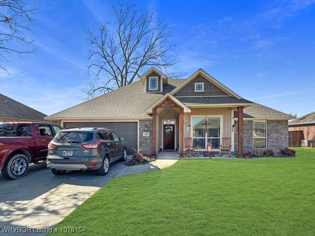 view of front facade with a garage, concrete driveway, roof with shingles, a front lawn, and a porch