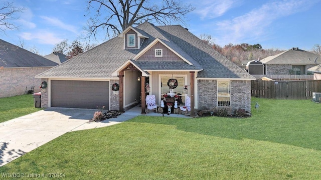 view of front of property featuring roof with shingles, concrete driveway, fence, a garage, and a front lawn