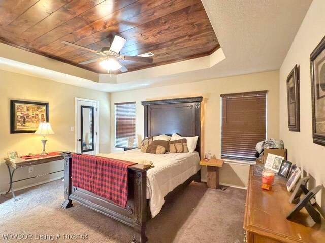 200 Honeysuckle St, Alma, AR 72921 - carpeted bedroom featuring wooden ceiling, a tray ceiling, and ceiling fan