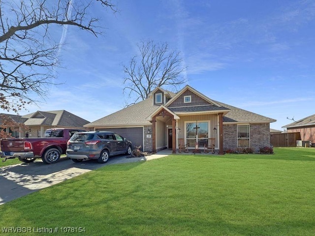 view of front facade with a garage, a front lawn, concrete driveway, and roof with shingles