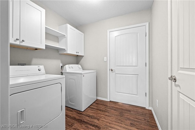 washroom featuring baseboards, dark wood finished floors, cabinet space, and washer and dryer