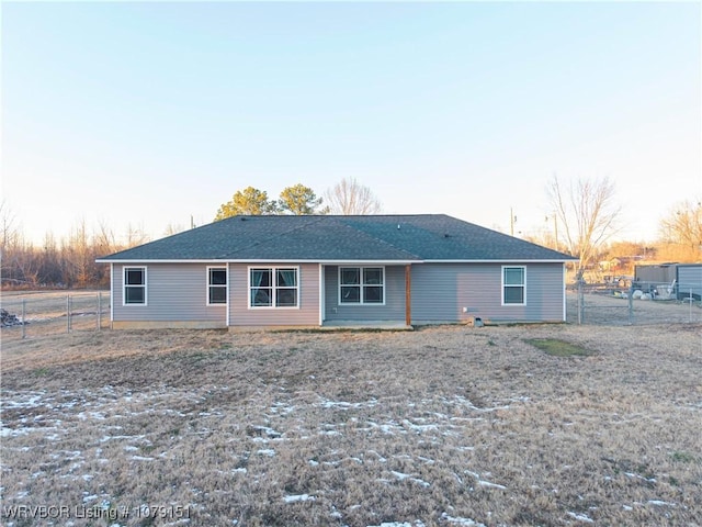 rear view of house featuring fence