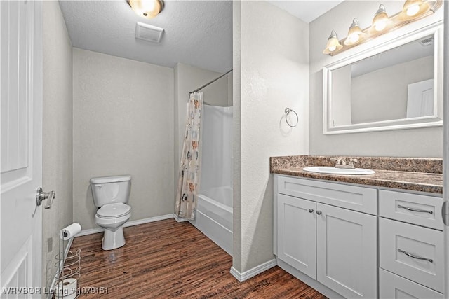 full bath with visible vents, wood finished floors, shower / bath combo with shower curtain, a textured ceiling, and vanity