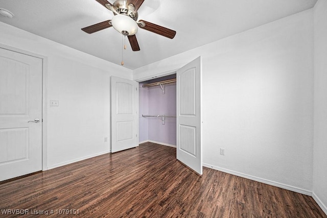 unfurnished bedroom featuring ceiling fan, a closet, baseboards, and dark wood-style flooring